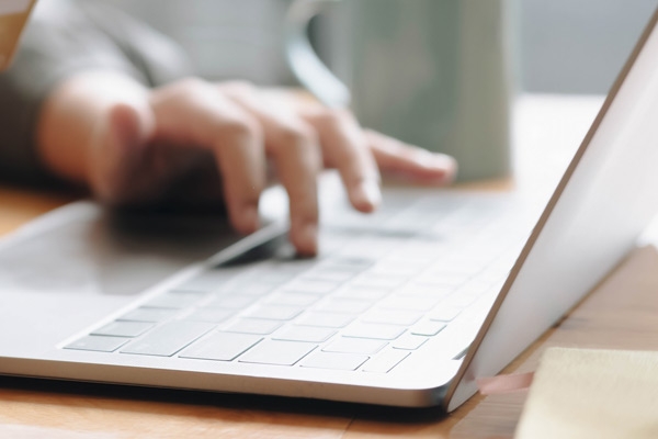 laptop computer with hand